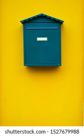 Elegant Simple Green Mail Box On A Yellow Wall.