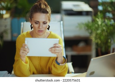 Elegant Small Business Owner Woman In Yellow Sweater In The Modern Green Office Using Tablet PC.