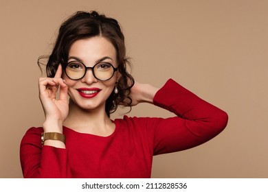 Elegant smiling female in round eyeglasses on beige background. Beauty portrait gorgeous woman in black frame spectacles. Vision correction, optical shop, glasses store. Optics and eyewear style. - Powered by Shutterstock