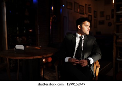 Elegant South Asian Indian Business Man In Black Suit Posed Indoor Cafe In Sun Shadows.