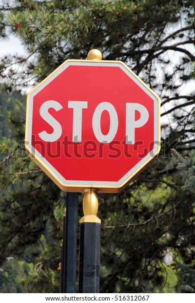 An elegant stop sign\
with golden border