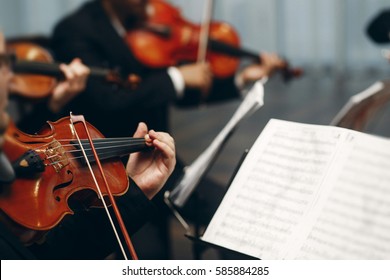 Elegant String Quartet Performing At Wedding Reception In Restaurant, Handsome Man In Suits Playing Violin And Cello At Theatre Play Orchestra Close-up, Music Concept