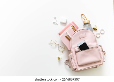 Elegant Student Female Backpack Full Of Schooler Supplies Isolated On White With Copy Space. Top View Personal College Bag Storage With Accessories And Electronic Devices. Back To School Concept