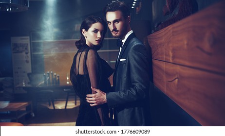 Elegant Stylish Couple Having A Date In A Modern Apartment. Evening Make-up And Hairstyle. Fashion Shot.