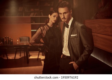 Elegant Stylish Couple Having A Date In A Modern Apartment. Evening Make-up And Hairstyle. Fashion Shot.