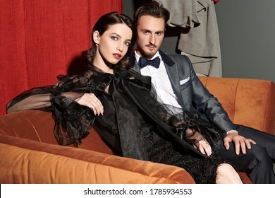 Elegant Stylish Couple Are Sitting A Date In A Modern Apartment. Evening Make-up And Hairstyle. Fashion Shot.