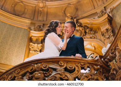 Elegant Stylish Newlywed Couple Lovingly Embracing In Luxurious Interior Of Old Classic Mansion