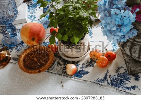 Elegant Summer Table Setting with Pecan Tart, Fresh Peaches, and Blue Toile Tablecloth
