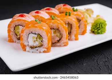 Elegant sushi rolls with salmon, avocado, and cream cheese, served with wasabi and ginger - Powered by Shutterstock