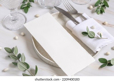 Elegant Table setting with a blank card decorated with eucalyptus branches close up, Wedding Mockup. Romantic table with paper menu card. Close to nature and simplicity concepts - Powered by Shutterstock