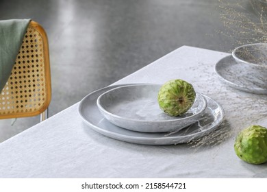 Elegant Table Setting With Cherimoya Fruits On Linen Tablecloth. Outdoor Table Setting For Summer Holiday Concept.