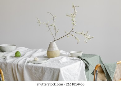 Elegant table setting with cherry brunch in craft vase , cherimoya fruits, garlic in craft ceramic plate on linen tablecloth. Outdoor table setting for summer holiday concept.