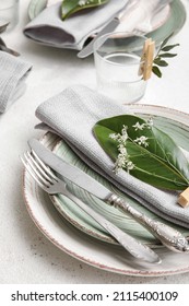 Elegant Table Setting With Floral Decor On Light Background