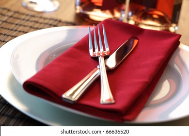 Elegant table setting with fork, knife and red napkin - Powered by Shutterstock