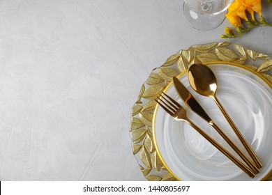 Elegant Table Setting With Freesia On Grey Background, Top View. Space For Text