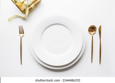 Elegant Table Setting With Golden Cutlery On White Background. Top View. Top View. Romantic Dinner. Christmas Holiday Time. Xmas Party.