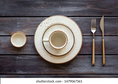 Elegant table setting with plates and tableware on wooden background top view
