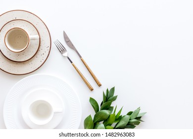 Elegant table setting with plates and tableware on white background top view copyspace