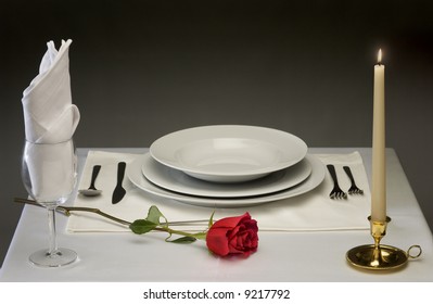 Elegant table setting with rose and candlelight