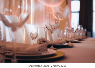 Elegant table settings with glasses, plates, and napkins awaiting guests at a special occasion or holiday celebration