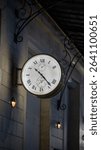 Elegant vintage wall-mounted clock with Roman numerals, showing the time 10:23. The clock features the year 1846 and uses IIII instead of IV for the number four. Mounted on a building facade