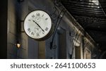 Elegant vintage wall-mounted clock with Roman numerals, showing the time 10:23. The clock features the year 1846 and uses IIII instead of IV for the number four. Mounted on a building facade