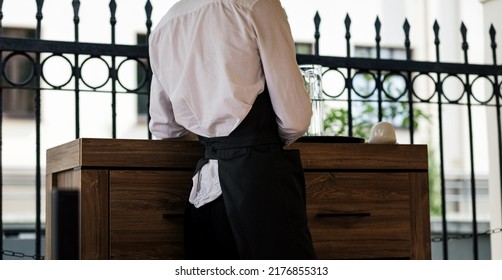 Elegant Waiter Wearing Black Apron And White Shirt 