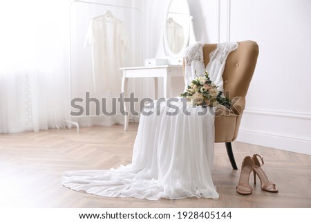 Elegant wedding dress, shoes and bouquet in room Photo stock © 
