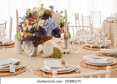 Elegant wedding reception area, ready for guests and the bridal party. Rich bunch of flowers table.