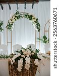 Elegant Wedding Reception Decor with Floral Arrangements and Gold Accents.