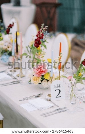 Elegant Wedding Reception Table Setting with Floral Centerpieces