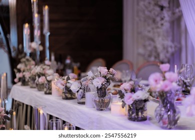 Elegant wedding table setting with pink floral arrangements, candles, and glassware, creating a romantic ambiance. - Powered by Shutterstock