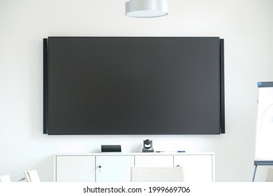 elegant white and bright office equipped with large LCD screen and remote conference call system - Powered by Shutterstock