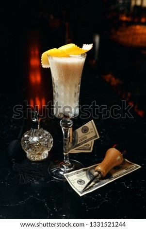Elegant white cocktail.Close up cocktail shot on the dark bar on dark background