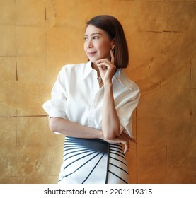 Elegant Lady​ In​ White Dress​ In Modern​ Corporate ​building​ Lobby.