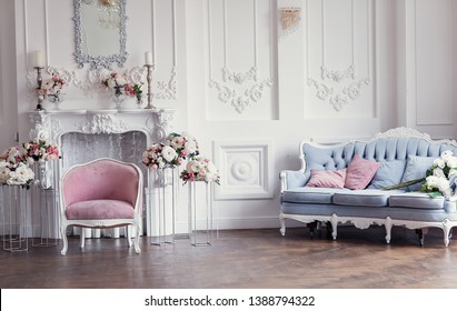 Elegant White Fireplace Full Of Flowers. Elegant White Room Decorated With Easel And Hat Boxes. Wedding Decorated Area. Vintage Decor In Light Interior 