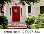 Elegant white house with bright red front door