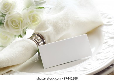 Elegant White Wedding Place Setting With Beautiful White Roses And A Blank Card