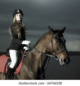 Elegant Woman In A Black Coat Riding On A Brown Horse