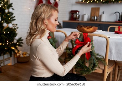 Elegant woman decorating room for Christmas dinner - Powered by Shutterstock