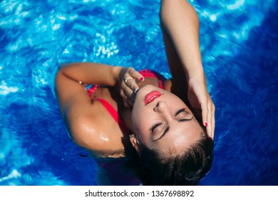 Elegant Woman With Fashion Waterproof Makeup In Swimming Pool. Sexy Girl. View From The Top