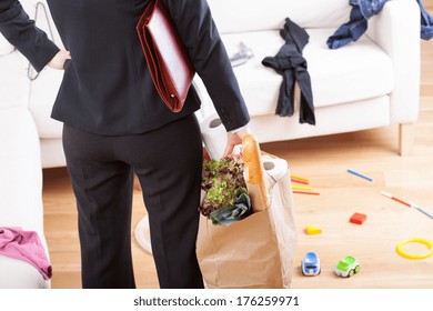 An Elegant Woman With Grocery Shopping Left In A Messy Home