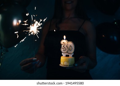 Elegant Woman Holding A Cake With Candle Celebrating Her 30th Birthday. 