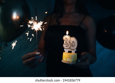 Elegant Woman Holding A Cake With Candle Celebrating Her 30th Birthday. 