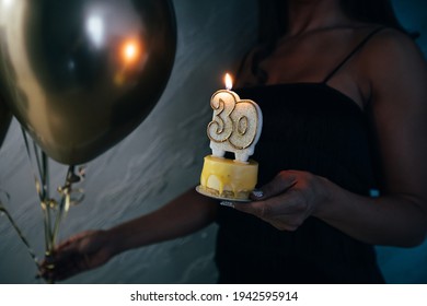 Elegant Woman Holding A Cake With Candle Celebrating Her 30th Birthday. 