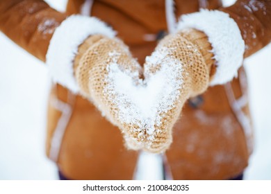 Elegant Woman With Mittens Showing Heart Shaped Hands Outside In The City Park In Winter.