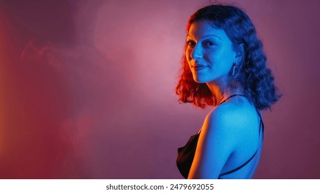 Elegant woman. Neon portrait. Night party. Blue color light smiling girl in evening dress in purple smoke cloud empty space background. - Powered by Shutterstock