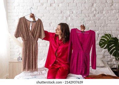 elegant woman in pajamas chooses a dress for a date. Stylish clothes, fashion
