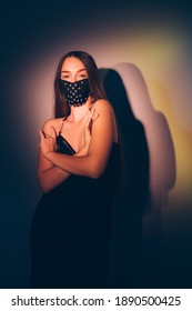 Elegant Woman. Pandemic Fashion. Classic Dress Code. Sensual Lady In Black Evening Dress Designer Crystal Beads Face Mask Posing On Shadow Lights Background.