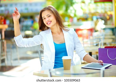 Elegant Woman Sitting At Table Asking For The Bill By Gesture